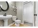 Bathroom with pedestal sink, toilet, and shower at 9985 Ford Valley Ln, Zionsville, IN 46077