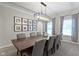 Elegant dining room featuring a large dining table, modern chandelier, and stylish decor at 9985 Ford Valley Ln, Zionsville, IN 46077