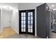 Hallway featuring hardwood floors, door, and adjacent kitchen at 9985 Ford Valley Ln, Zionsville, IN 46077