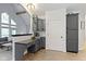 Open-concept kitchen with gray cabinets, countertop workspace, and view of a living area at 9985 Ford Valley Ln, Zionsville, IN 46077