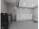 Bright laundry room with a front load washer/dryer set and white cabinets at 9985 Ford Valley Ln, Zionsville, IN 46077