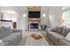 Cozy living room featuring a stone fireplace, neutral decor, and comfortable seating for relaxation at 9985 Ford Valley Ln, Zionsville, IN 46077