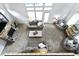 Bright living room with a stone fireplace, large windows, and cozy seating for relaxation at 9985 Ford Valley Ln, Zionsville, IN 46077