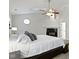 Main bedroom with fireplace, fan, and octagonal window at 9985 Ford Valley Ln, Zionsville, IN 46077