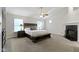Main bedroom with fireplace, fan, and high ceilings at 9985 Ford Valley Ln, Zionsville, IN 46077
