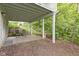 A covered patio offers a quiet retreat with views of the backyard and surrounding greenery at 9985 Ford Valley Ln, Zionsville, IN 46077