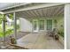 A covered patio with stone exterior provides a cozy outdoor space for relaxation and entertainment at 9985 Ford Valley Ln, Zionsville, IN 46077