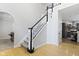Elegant staircase featuring hardwood floors, and a view into the dining and kitchen areas at 9985 Ford Valley Ln, Zionsville, IN 46077