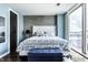 Modern bedroom with a luxurious bed, stylish decor, and large window at 1 Virginia Ave # 607, Indianapolis, IN 46204