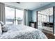 Cozy bedroom with a large window offering city views, and a view into the living area at 1 Virginia Ave # 607, Indianapolis, IN 46204