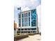 Modern commercial building with blue glass accents and a flag at 1 Virginia Ave # 607, Indianapolis, IN 46204