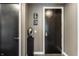 Neutral hallway featuring dark doors, contemporary art and modern pedestal with sculpture at 1 Virginia Ave # 607, Indianapolis, IN 46204