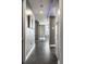 Hallway featuring tile flooring, contemporary art and decorative lighting leading into open living area at 1 Virginia Ave # 607, Indianapolis, IN 46204