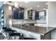Open concept kitchen features stainless steel appliances, blue and white cabinets and granite countertops at 1 Virginia Ave # 607, Indianapolis, IN 46204