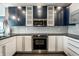 Beautiful kitchen features stainless steel appliances, blue and white cabinetry and tile backsplash at 1 Virginia Ave # 607, Indianapolis, IN 46204