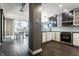 Modern kitchen with white and navy cabinets, stainless steel appliances, open to dining area and city views at 1 Virginia Ave # 607, Indianapolis, IN 46204