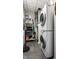 Efficient laundry room with stacked washer and dryer, shelving, and ample storage space at 1 Virginia Ave # 607, Indianapolis, IN 46204