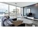 Living room with a large window offering city views, comfortable seating, and stylish decor at 1 Virginia Ave # 607, Indianapolis, IN 46204