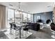 Open concept living area with comfortable seating, modern lighting and city views through large windows at 1 Virginia Ave # 607, Indianapolis, IN 46204