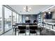 Living area featuring city views through large windows, adjacent dining area and modern décor at 1 Virginia Ave # 607, Indianapolis, IN 46204