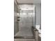 Beautiful glass-enclosed shower featuring sleek gray tile, mosaic accents, and a rainfall showerhead at 1 Virginia Ave # 607, Indianapolis, IN 46204