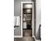 Spacious walk-in closet features custom shelving, dark wood cabinets, and ample hanging space at 1 Virginia Ave # 607, Indianapolis, IN 46204