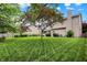 Expansive backyard with lush lawn and mature trees, perfect for outdoor activities at 10758 Gettysburg Pl, Carmel, IN 46032