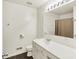 Clean bathroom with a large mirror, modern lighting, and a sink with cabinet storage at 10758 Gettysburg Pl, Carmel, IN 46032