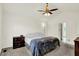 Bedroom features neutral carpet, vaulted ceiling, ceiling fan, and an ensuite at 10758 Gettysburg Pl, Carmel, IN 46032