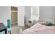 Bright bedroom with a plush chair and a cozy bed with a soft pink comforter at 10758 Gettysburg Pl, Carmel, IN 46032