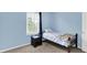 Cozy bedroom with a twin bed, wooden bed frame, and a natural light window at 10758 Gettysburg Pl, Carmel, IN 46032