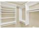 Custom closet features a wall of shelving and multiple clothing rods at 10758 Gettysburg Pl, Carmel, IN 46032