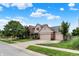 Two-story home with manicured lawn, brick and siding exterior, and a three-car garage in a suburban neighborhood at 10758 Gettysburg Pl, Carmel, IN 46032