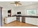 Bright kitchen with white cabinets, stainless steel appliances, granite countertops, and modern fixtures at 10758 Gettysburg Pl, Carmel, IN 46032