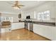 Modern kitchen featuring white cabinets, stainless steel appliances, granite countertops, and a seamless flow to the living room at 10758 Gettysburg Pl, Carmel, IN 46032