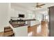 Bright kitchen with white cabinets, stainless steel appliances, granite countertops, and an open view to the dining area at 10758 Gettysburg Pl, Carmel, IN 46032