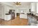 Open kitchen with stainless steel appliances, white cabinetry, granite countertops, and a seamless flow into the living area at 10758 Gettysburg Pl, Carmel, IN 46032