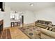 Spacious living room with hardwood floors, comfortable seating, fireplace and eat-in kitchen at 10758 Gettysburg Pl, Carmel, IN 46032