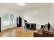 Bright office with a large window, hardwood flooring, a desk, a chair and a piano at 10758 Gettysburg Pl, Carmel, IN 46032