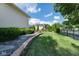 Lush backyard featuring a stone paver path, manicured lawn, and privacy trees, creating a serene outdoor space at 12505 Branford St, Carmel, IN 46032