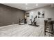 Finished basement with living and exercise areas with bar seating at 12505 Branford St, Carmel, IN 46032