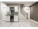 Finished basement with a wet bar featuring wine racks and a beverage cooler, plus a staircase at 12505 Branford St, Carmel, IN 46032