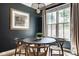 Cozy dining room features a round table, modern light fixture, and a window view at 12505 Branford St, Carmel, IN 46032