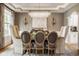 Elegant dining room featuring a crystal chandelier, designer chairs and refined wall decor at 12505 Branford St, Carmel, IN 46032