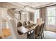 Beautiful dining room showcasing elegant chandelier, neutral color palette and staircase in background at 12505 Branford St, Carmel, IN 46032