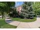 Charming brick home framed by mature trees and manicured lawn, creating a welcoming curb appeal at 12505 Branford St, Carmel, IN 46032