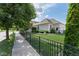 Charming home with manicured landscaping, fenced yard, and convenient access to the sidewalk at 12505 Branford St, Carmel, IN 46032