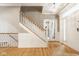 Welcoming foyer with hardwood floors, staircase, wainscoting, and ample natural light highlighting the elegant interior at 12505 Branford St, Carmel, IN 46032
