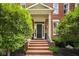 Inviting front entrance featuring brick steps, a covered porch, and manicured bushes creating a welcoming facade at 12505 Branford St, Carmel, IN 46032