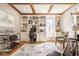 Spacious home office features custom built-ins, coffered ceilings and a comfortable seating area at 12505 Branford St, Carmel, IN 46032